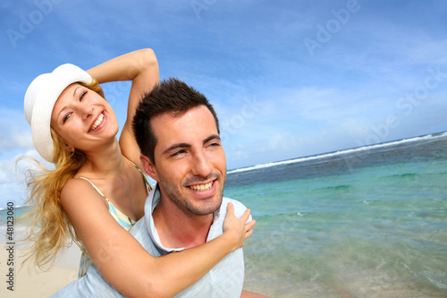 Photo: Cheerful couple enjoying vacation at the beach Cheerful couple enjoying vacation at the beach