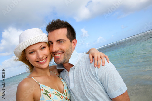 Photo: Portrait of cheerful couple at the beach Portrait of cheerful couple at the beach