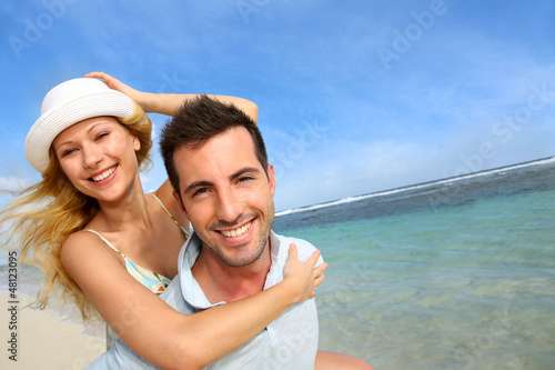 Photo: Cheerful couple enjoying vacation at the beach Cheerful couple enjoying vacation at the beach