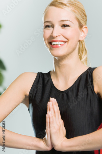 Photo: Blond woman meditating, indoors Blond woman meditating, indoors