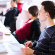 Photo: young, handsome male college student sitting in a classroom young, handsome male college student sitting in a classroom