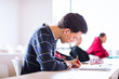 Photo: young, handsome male college student sitting in a classroom young, handsome male college student sitting in a classroom