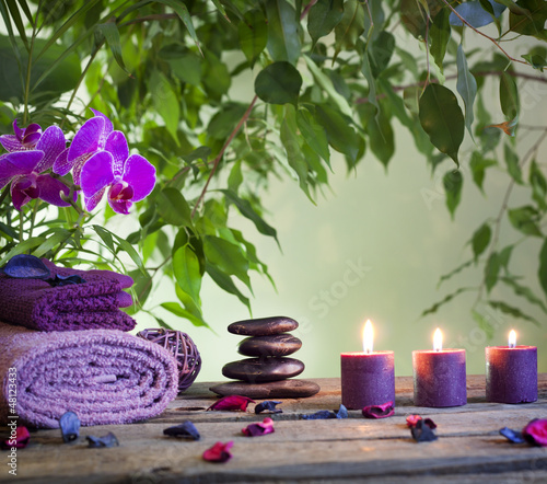 Photo: Spa still life with zen stones aromatic candles and orchids Spa still life with zen stones aromatic candles and orchids