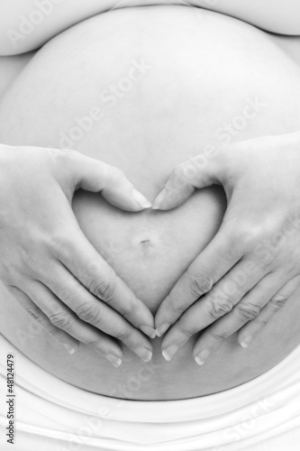 Photo: Pregnant woman making a heart sign Pregnant woman making a heart sign