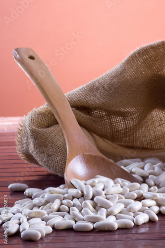 Photo: White beans - Cannellini (legumes) in a wooden spoon and bag White beans - Cannellini (legumes) in a wooden spoon and bag