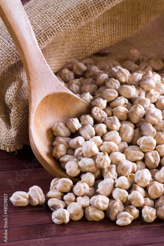Photo: Chickpeas in a wooden spoon and bag Chickpeas in a wooden spoon and bag