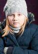 Cold child in winter clothing