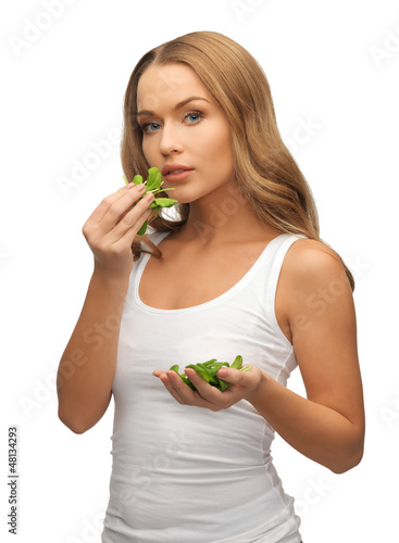 Photo: woman with spinach leaves on palms woman with spinach leaves on palms
