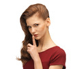 teenage girl in red dress with finger on lips