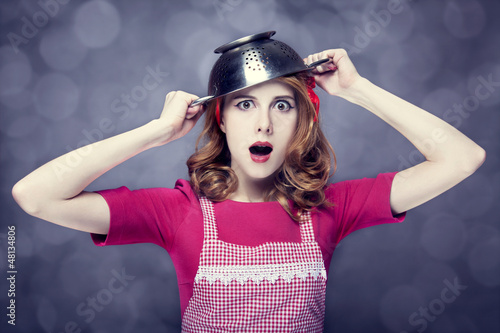 Photo: Redhead housewife with colander over head Redhead housewife with colander over head
