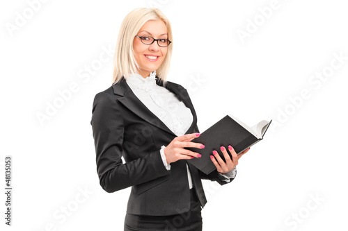 Photo: A blond female teacher holding a book A blond female teacher holding a book
