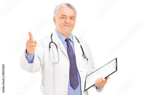 Photo: A male doctor standing and giving a thumb up A male doctor standing and giving a thumb up