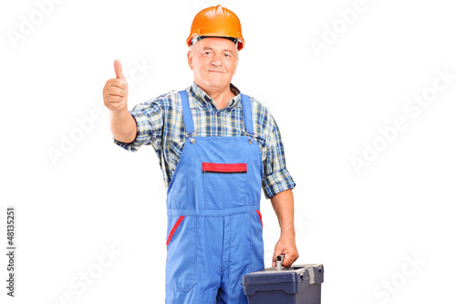 Photo: A manual worker holding tool box and giving a thumb up A manual worker holding tool box and giving a thumb up