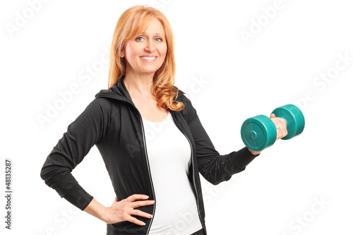 Photo: A mature woman lifting up a dumbbell A mature woman lifting up a dumbbell