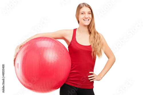 Photo: A young female athlete holding a pilates ball A young female athlete holding a pilates ball