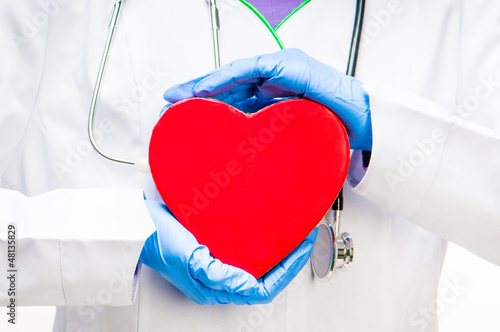 Photo: doctor holding red heart doctor holding red heart