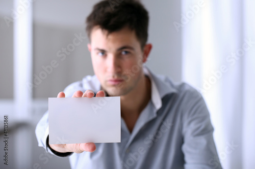 Photo: man who shows a business card man who shows a business card