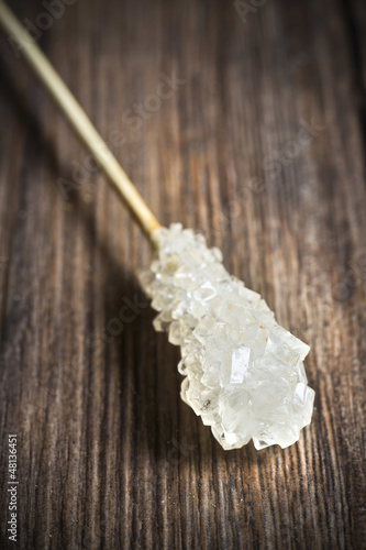 Photo: Sugar sticks isolated on wooden background Sugar sticks isolated on wooden background
