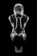 Photo: Naked woman on black background Naked woman on black background