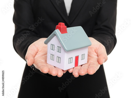 Photo: Real estate agent showing small house / home Real estate agent showing small house / home
