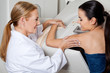 Photo: Doctor Assisting Patient During Mammography Doctor Assisting Patient During Mammography