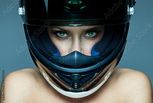 Photo: Sexy woman in helmet on blue background Sexy woman in helmet on blue background
