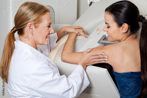 Photo: Doctor Assisting Patient During Mammography Doctor Assisting Patient During Mammography