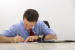 Busy businessman filling paper documents
