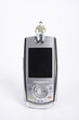 Male figurine sitting on top of mobile phone