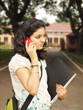 Beautiful Indian / Asian college student talking on Cellphone.