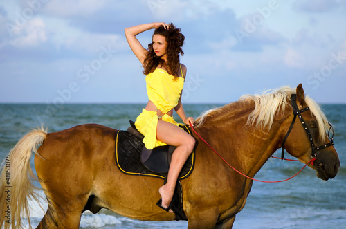 Photo: Young woman riding a horse Young woman riding a horse