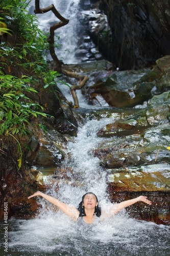Photo: Woman in wild waterfall Woman in wild waterfall
