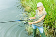 Photo: woman fishing in pond woman fishing in pond