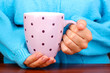 hands holding mug of hot drink close-up