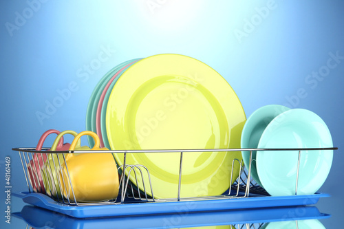 Photo: Color plates in rack on blue background Color plates in rack on blue background