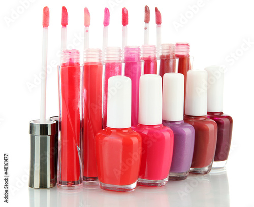 Photo: beautiful lip glosses and nail polish bottles, isolated on beautiful lip glosses and nail polish bottles, isolated on