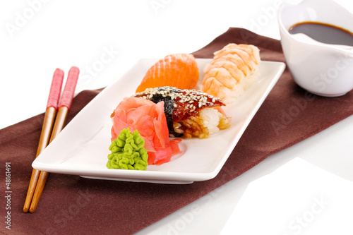 Photo: delicious sushi served on plate isolated on white delicious sushi served on plate isolated on white