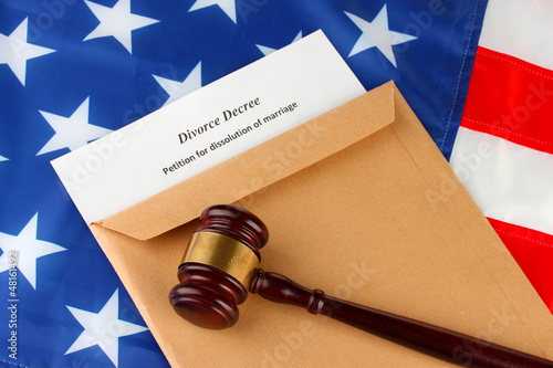 Photo: Divorce decree and envelope on american flag background Divorce decree and envelope on american flag background