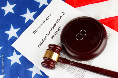 Photo: Divorce decree and wooden gavel on american flag background Divorce decree and wooden gavel on american flag background