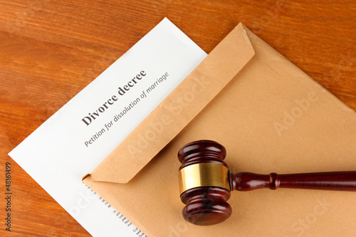 Photo: Divorce decree and envelope on wooden background Divorce decree and envelope on wooden background