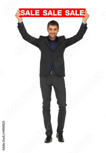 Photo: handsome man in suit with sale sign handsome man in suit with sale sign