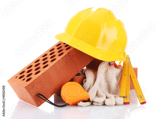 Photo: helmet, roulette, bricks and gloves isolated on white helmet, roulette, bricks and gloves isolated on white