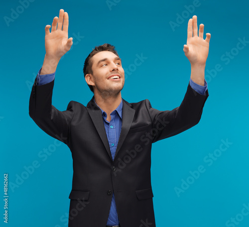 Photo: man in suit working with something imaginary man in suit working with something imaginary