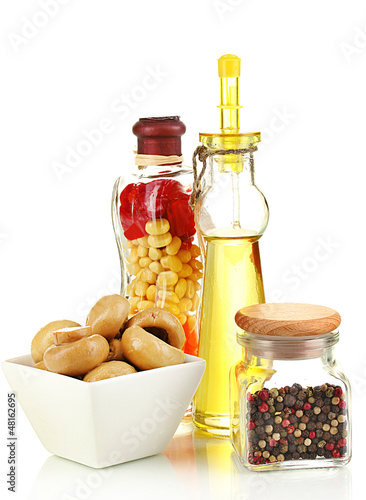 Photo: Delicious marinated mushrooms in bowl with spices isolated Delicious marinated mushrooms in bowl with spices isolated