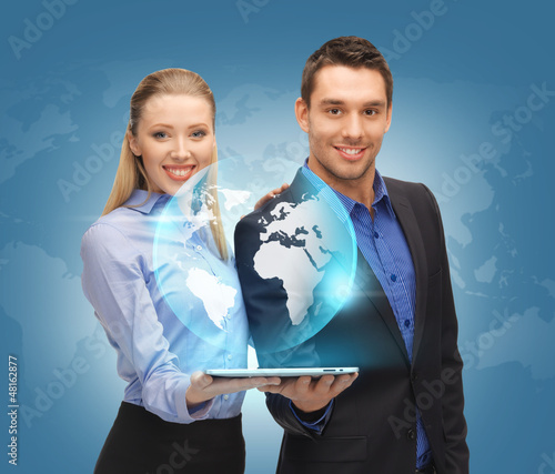 Photo: man and woman with tablet pc and virtual globe man and woman with tablet pc and virtual globe