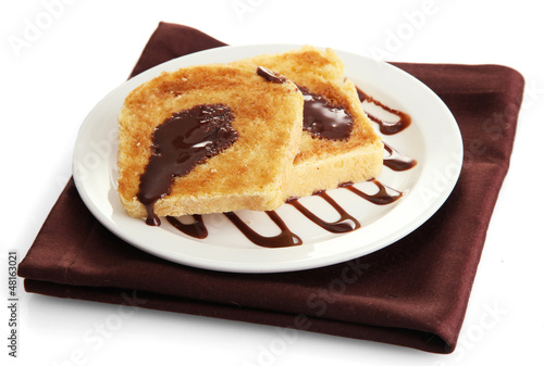 Photo: White bread toast with chocolate on plate, isolated on white White bread toast with chocolate on plate, isolated on white