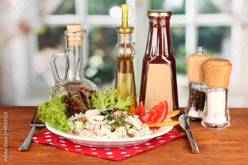 Photo: Tasty italian pasta with seafood on bright background Tasty italian pasta with seafood on bright background