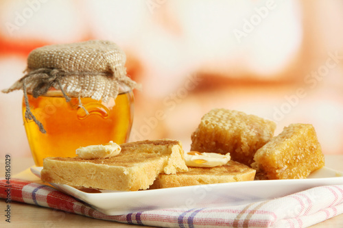 Photo: White bread toastwith honey on plate in cafe White bread toastwith honey on plate in cafe