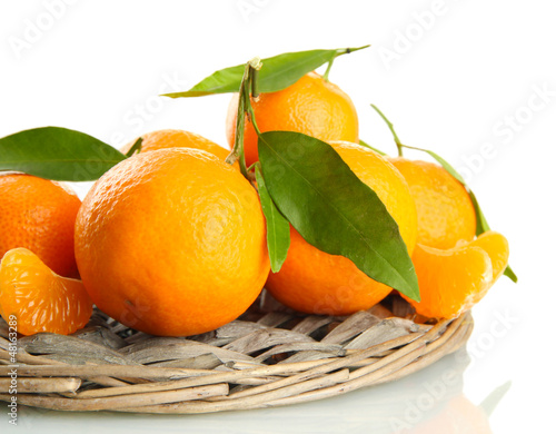 Photo: Ripe sweet tangerine with leaves, isolated on white Ripe sweet tangerine with leaves, isolated on white