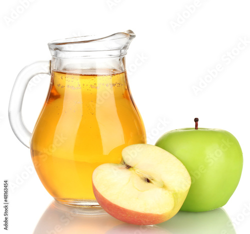Photo: Full jug of apple juice and apple isolated on white Full jug of apple juice and apple isolated on white